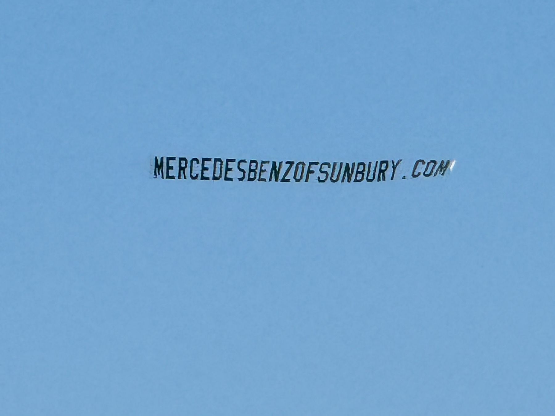 Letter banner for a car dealership website against a clear blue sky